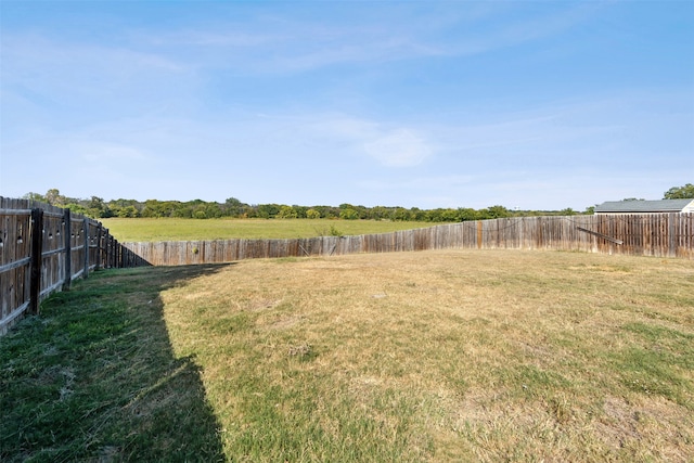 view of yard with a rural view