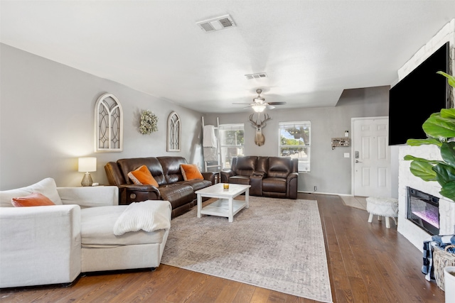 living room with dark hardwood / wood-style flooring and ceiling fan