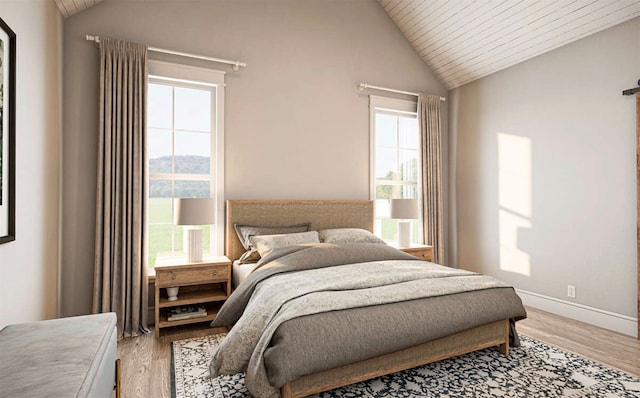 bedroom with light hardwood / wood-style floors, lofted ceiling, and multiple windows