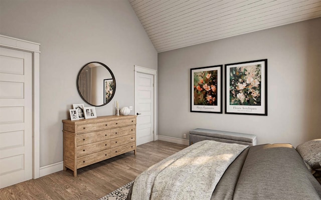 bedroom with wood ceiling, high vaulted ceiling, and light hardwood / wood-style floors