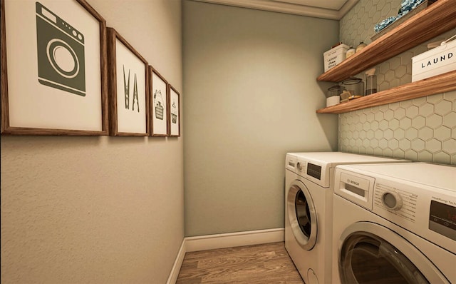 clothes washing area with washer and dryer and light hardwood / wood-style floors