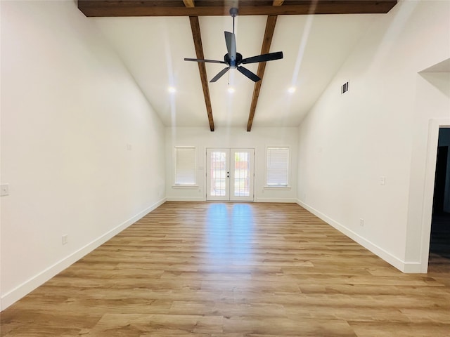 unfurnished living room with french doors, high vaulted ceiling, beamed ceiling, and light hardwood / wood-style flooring