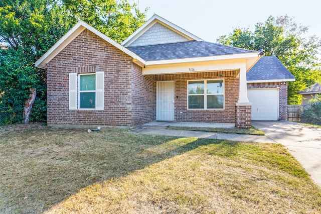 view of front of property with a front lawn and a garage