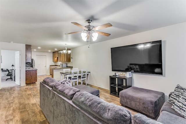 living room with ceiling fan, recessed lighting, and light wood-style floors