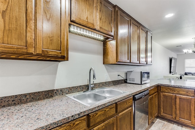 kitchen featuring light hardwood / wood-style floors, a notable chandelier, stainless steel dishwasher, and sink