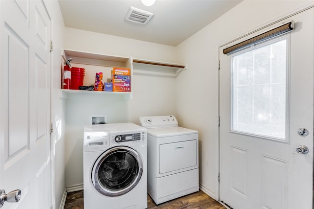 clothes washing area with independent washer and dryer and dark hardwood / wood-style flooring