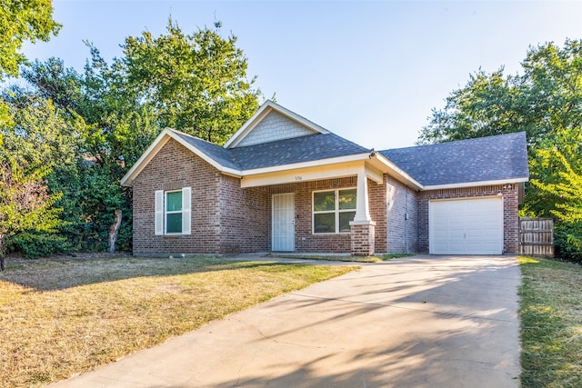 view of front of house with a garage and a front lawn