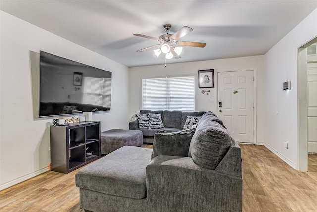 living room featuring light wood-type flooring and ceiling fan