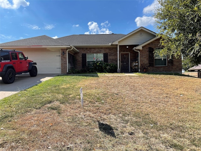 ranch-style house featuring a garage and a front lawn