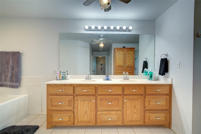 bathroom with tile patterned floors, vanity, and a tub to relax in