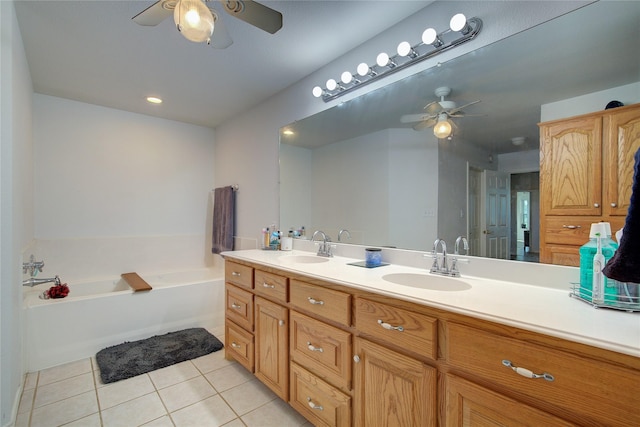 bathroom featuring tile patterned floors, vanity, ceiling fan, and a bathing tub