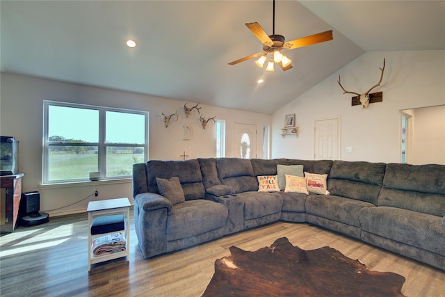 living room with hardwood / wood-style flooring, ceiling fan, and lofted ceiling