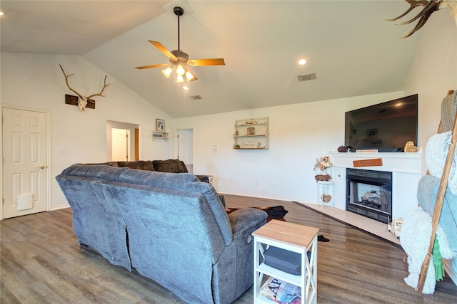 living room with ceiling fan, wood-type flooring, and lofted ceiling