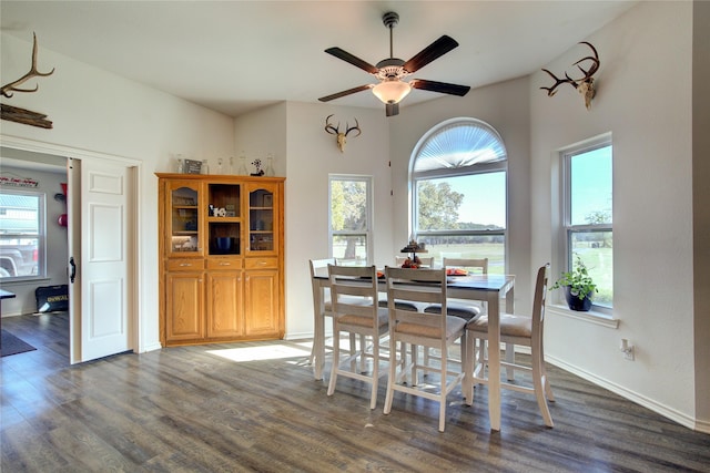 dining space with ceiling fan and dark hardwood / wood-style flooring