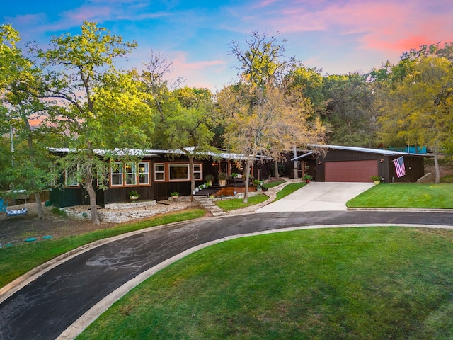 view of front of house with a yard and a garage