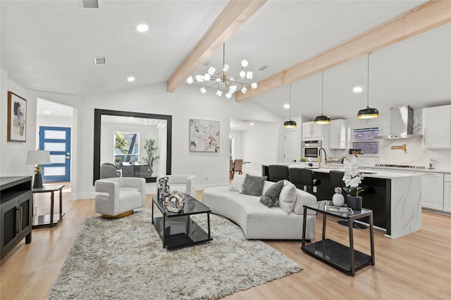 living room with vaulted ceiling with beams, light hardwood / wood-style flooring, and an inviting chandelier