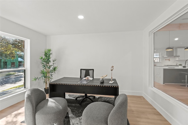 office area with light hardwood / wood-style flooring