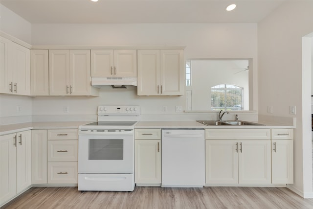 kitchen featuring white cabinets, sink, light wood-type flooring, and white appliances