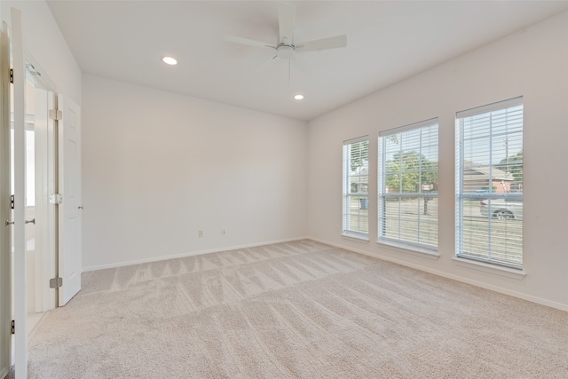 spare room with light carpet and ceiling fan