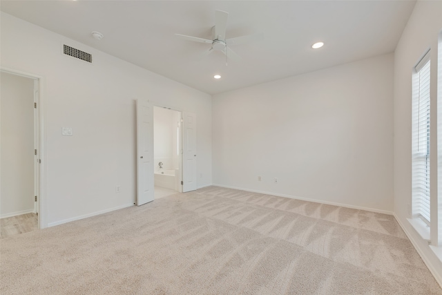 carpeted spare room featuring ceiling fan