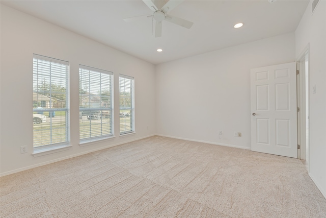 carpeted spare room with ceiling fan