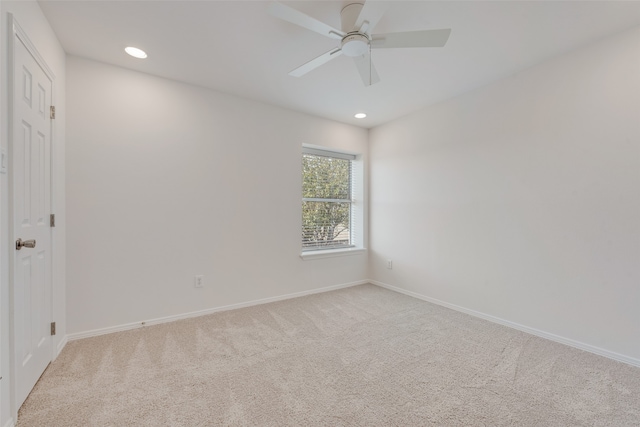 spare room featuring ceiling fan and light colored carpet