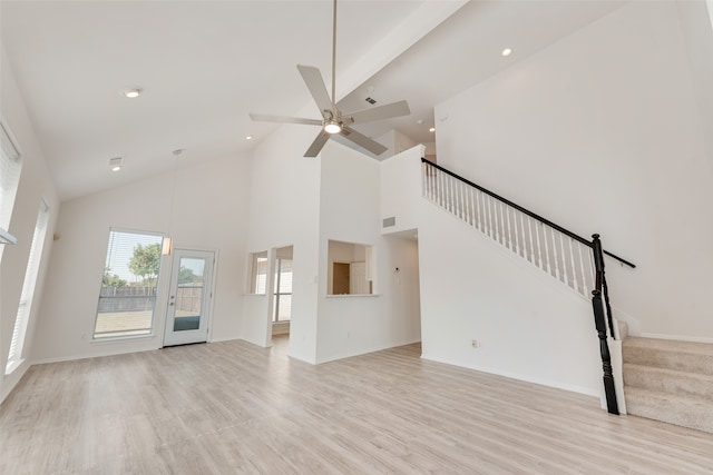 unfurnished living room featuring light hardwood / wood-style floors, beamed ceiling, high vaulted ceiling, and ceiling fan