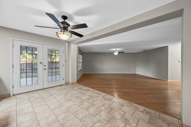 spare room with light hardwood / wood-style flooring, french doors, and ceiling fan