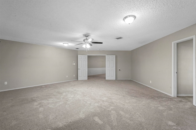 unfurnished bedroom featuring a textured ceiling, carpet floors, and ceiling fan