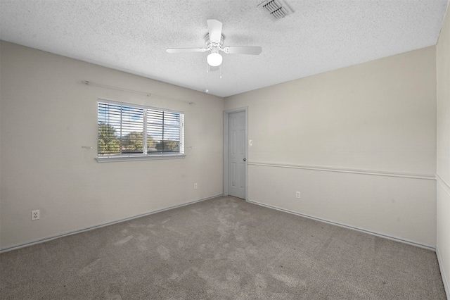 carpeted empty room with a textured ceiling and ceiling fan