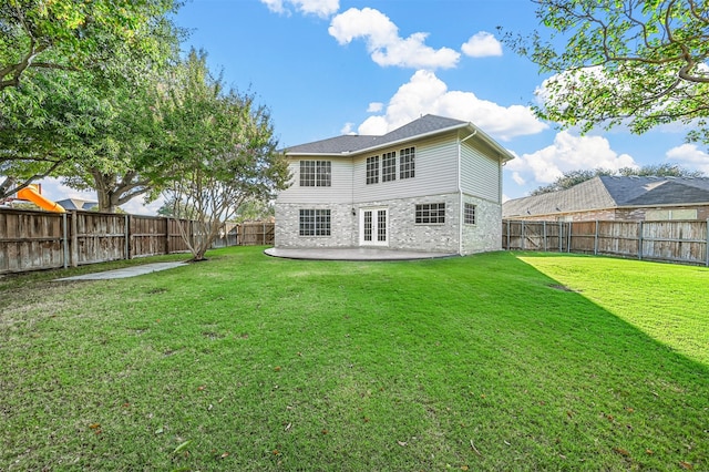 back of house featuring a patio area and a lawn