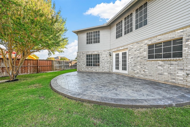 back of property featuring a yard and a patio area