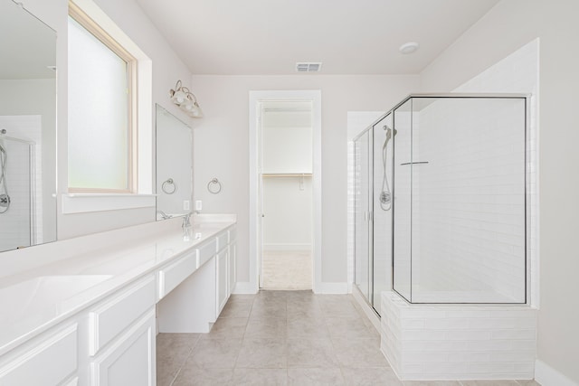 bathroom with vanity, tile patterned flooring, and a shower with door