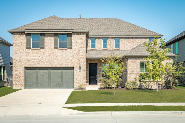 view of front of property featuring a garage and a front yard