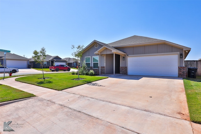 view of front of home featuring a front lawn and a garage