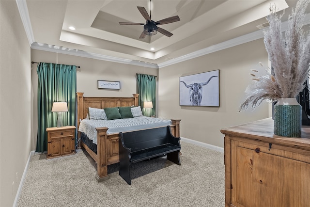 bedroom with ornamental molding, a raised ceiling, light colored carpet, and ceiling fan