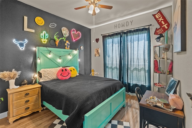 bedroom with hardwood / wood-style floors and ceiling fan