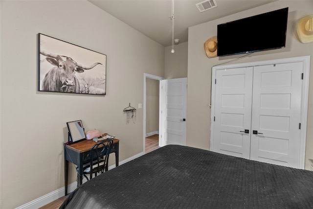 unfurnished bedroom featuring wood-type flooring and a closet