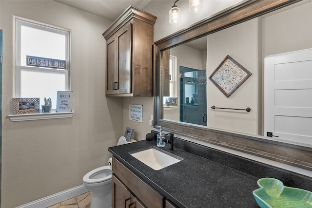 bathroom featuring vanity, toilet, and tile patterned floors