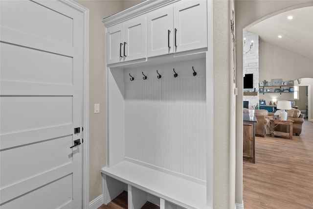 mudroom with light wood-type flooring and a fireplace