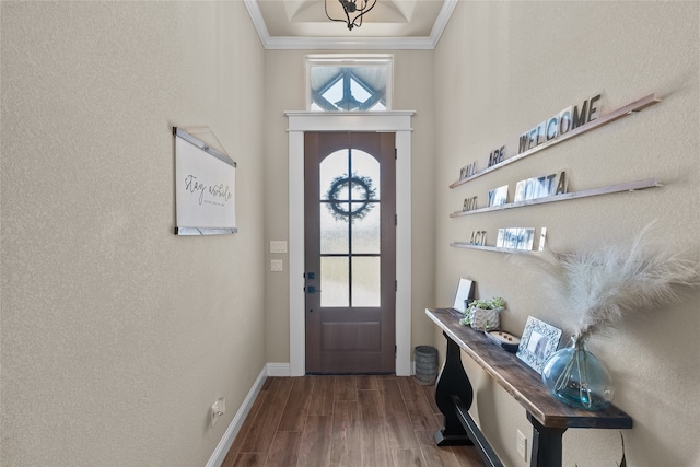 doorway to outside with ornamental molding, an inviting chandelier, and hardwood / wood-style floors