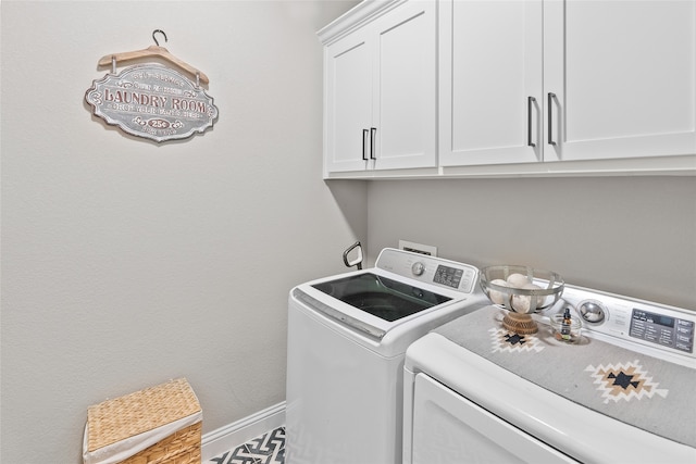 laundry room featuring washer and dryer and cabinets