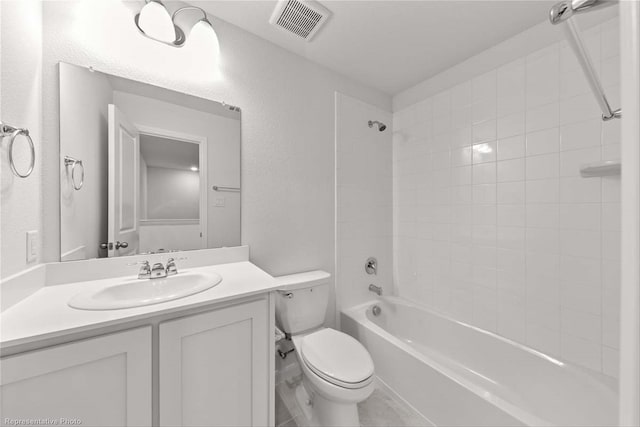 full bathroom with tiled shower / bath, toilet, and vanity