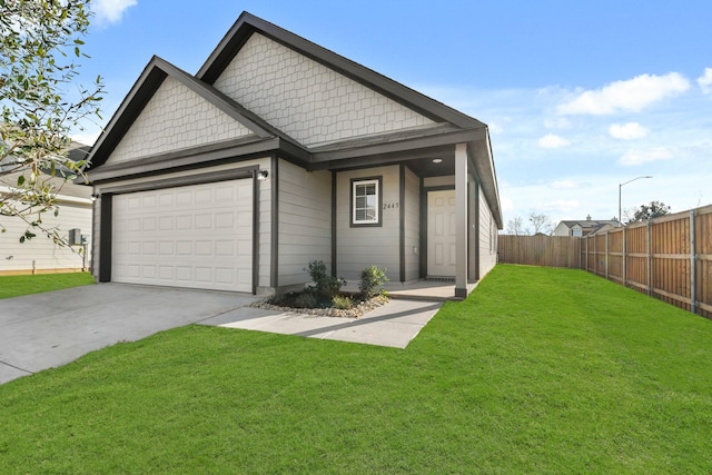 view of front of home featuring a garage and a front lawn