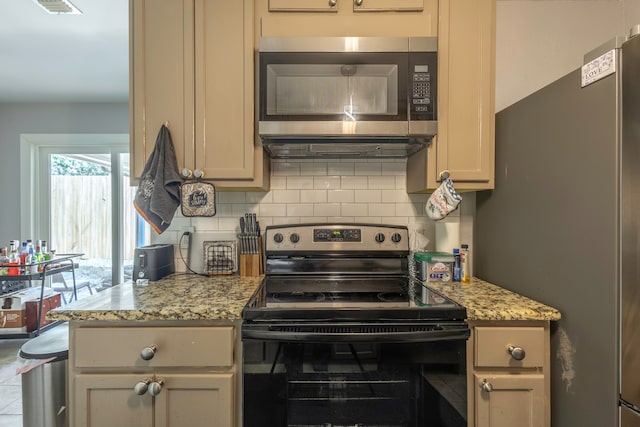 kitchen featuring appliances with stainless steel finishes, decorative backsplash, and light stone counters