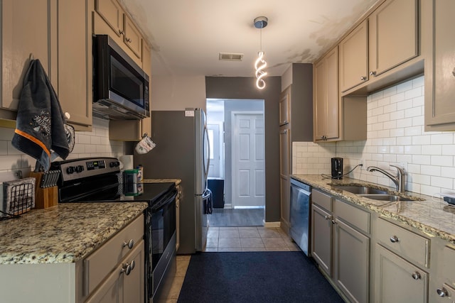 kitchen featuring hanging light fixtures, backsplash, light tile patterned flooring, sink, and stainless steel appliances