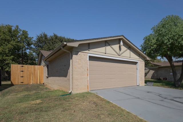 exterior space with a garage and a lawn