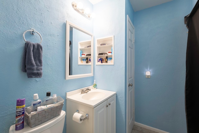 bathroom with vanity and toilet