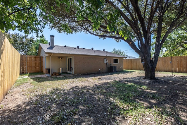 back of property with central AC