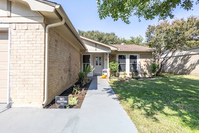 entrance to property featuring a yard